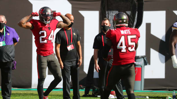 Tampa Bay Buccaneers cornerback Carlton Davis III (left) and linebacker Devin White (right) celebrate a play.